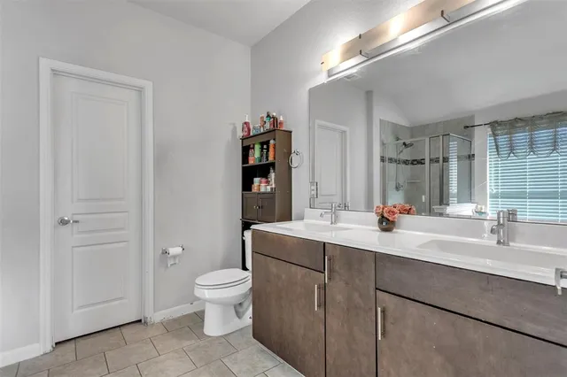 a en suite bathroom with a toilet a sink and mirror