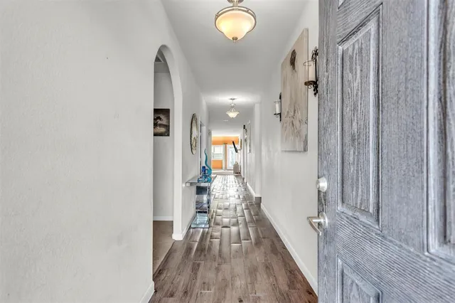 a view of a hallway with wooden floor
