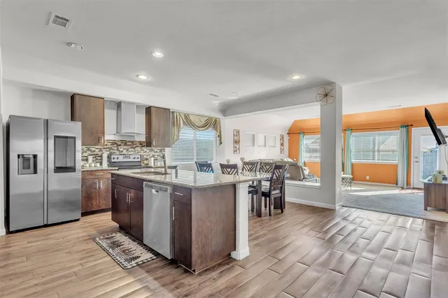 a kitchen with stainless steel appliances granite countertop a stove oven and a refrigerator