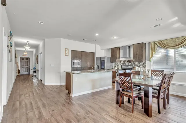 a kitchen with a table and chairs in it