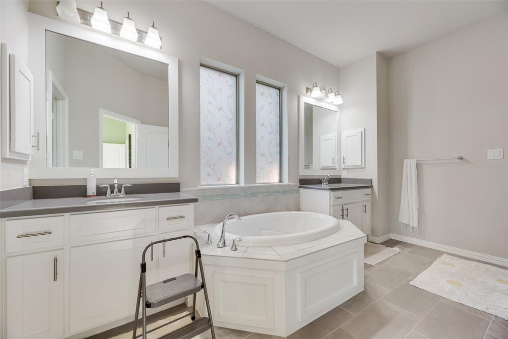 14809 Cedar Flt Way Fort Worth, TX 76262 - Photo 14 of 18 Full bathroom featuring a garden tub, two vanities, and light tile patterned floors