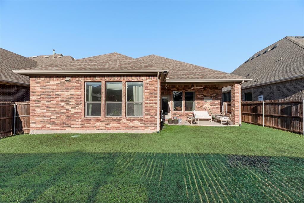 14809 Cedar Flt Way Fort Worth, TX 76262 - Photo 17 of 18 Rear view of house featuring a fenced backyard, a patio, roof with shingles, and brick siding