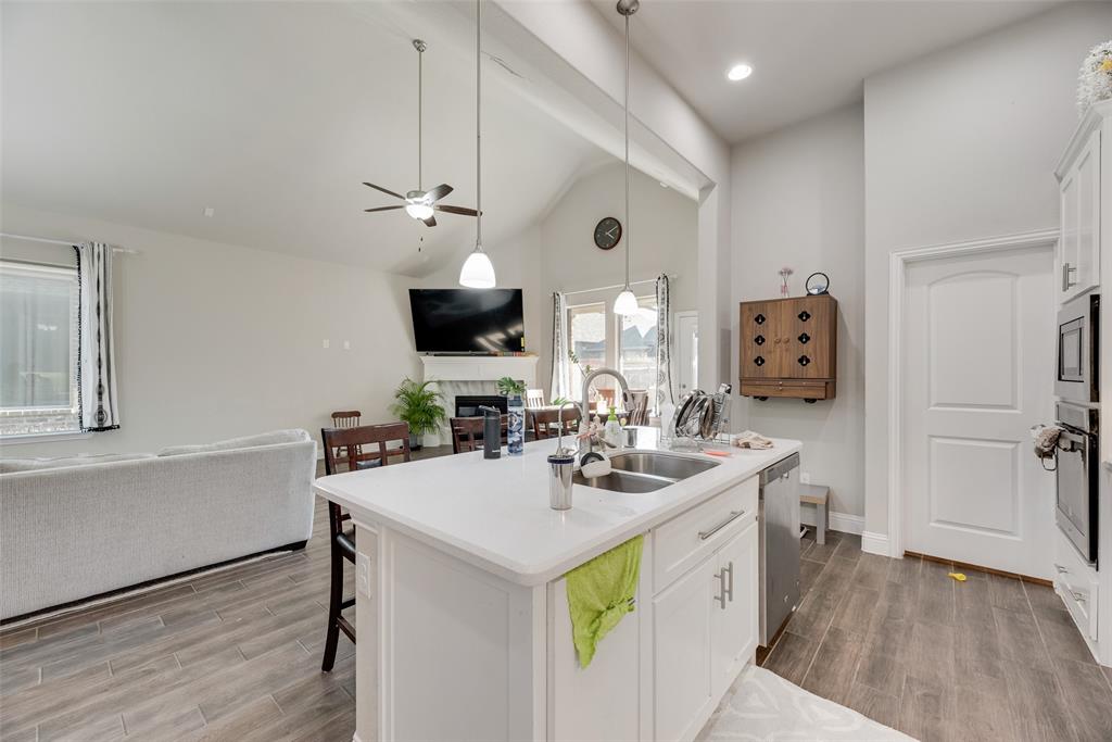 14809 Cedar Flt Way Fort Worth, TX 76262 - Photo 18 of 18 Kitchen with open floor plan, white cabinets, wood tiled floors, and high vaulted ceiling