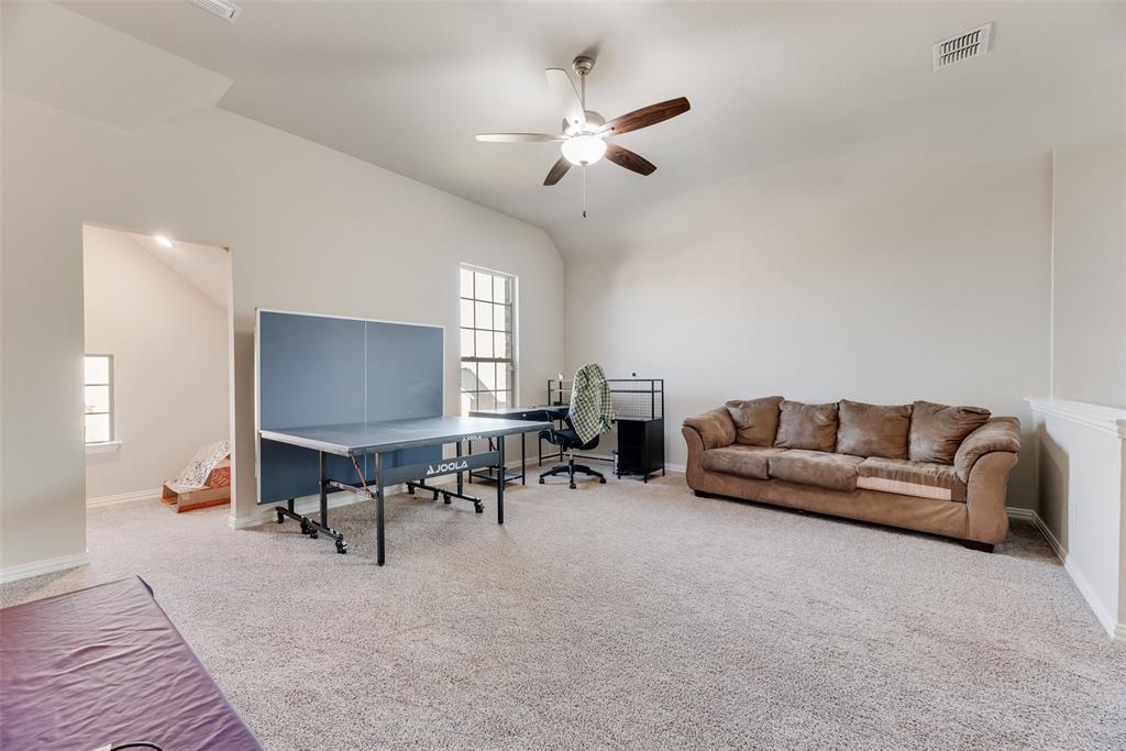 14809 Cedar Flt Way Fort Worth, TX 76262 - Photo 9 of 18 Game room with carpet flooring, lofted ceiling, and a ceiling fan