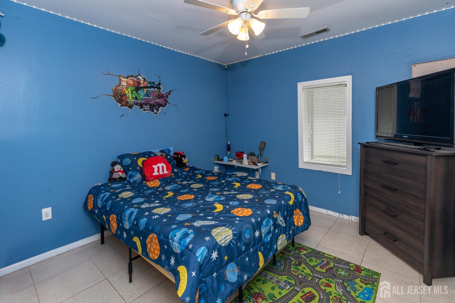 560 Lloyd Road Toms River, NJ 08753 - Photo 12 of 18 a bedroom with a bed and a flat screen tv