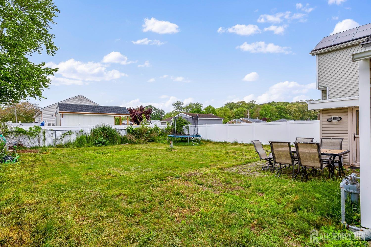 560 Lloyd Road Toms River, NJ 08753 - Photo 18 of 18 a view of a backyard with table and chairs and potted plants