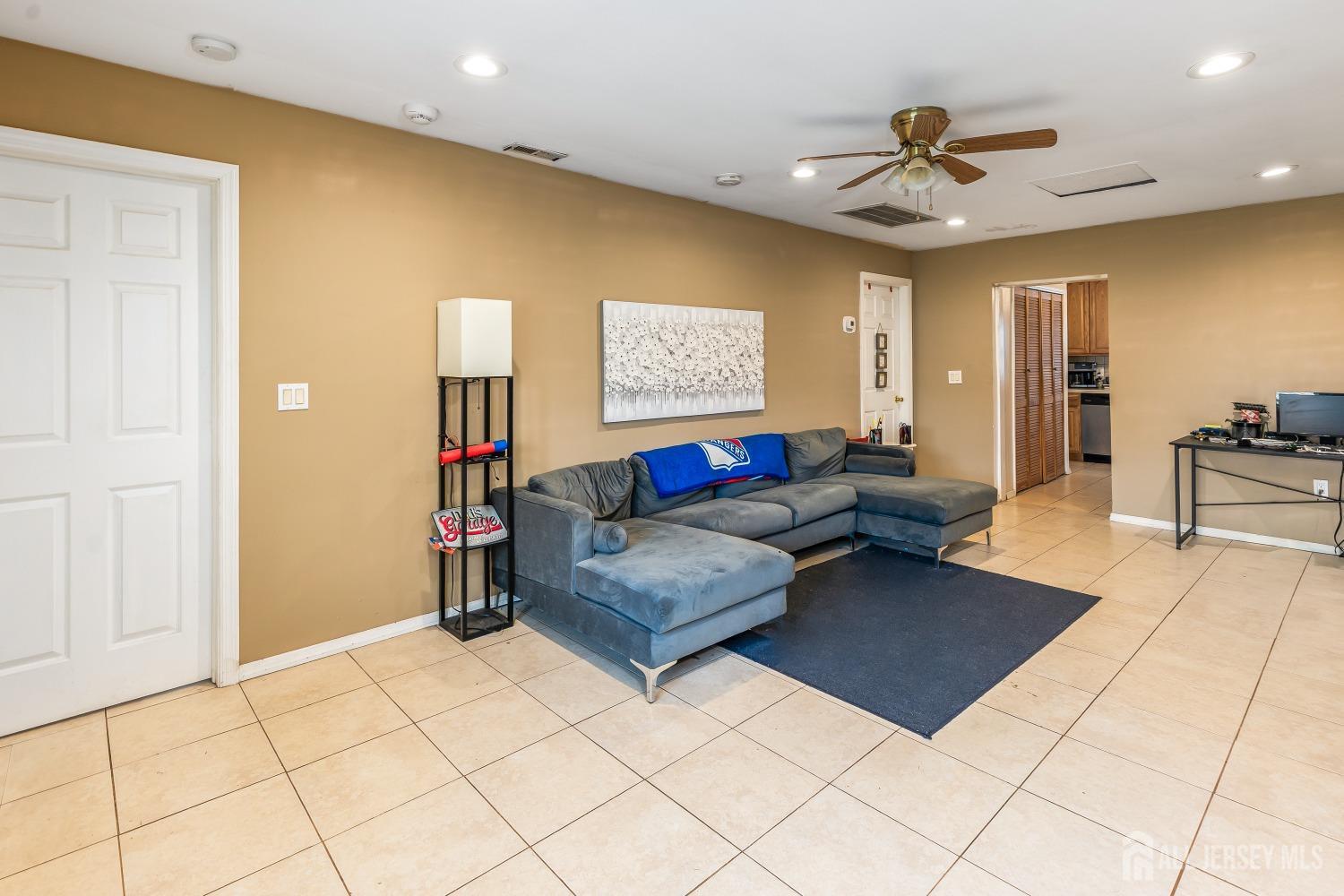 560 Lloyd Road Toms River, NJ 08753 - Photo 3 of 18 a living room with furniture and a flat screen tv