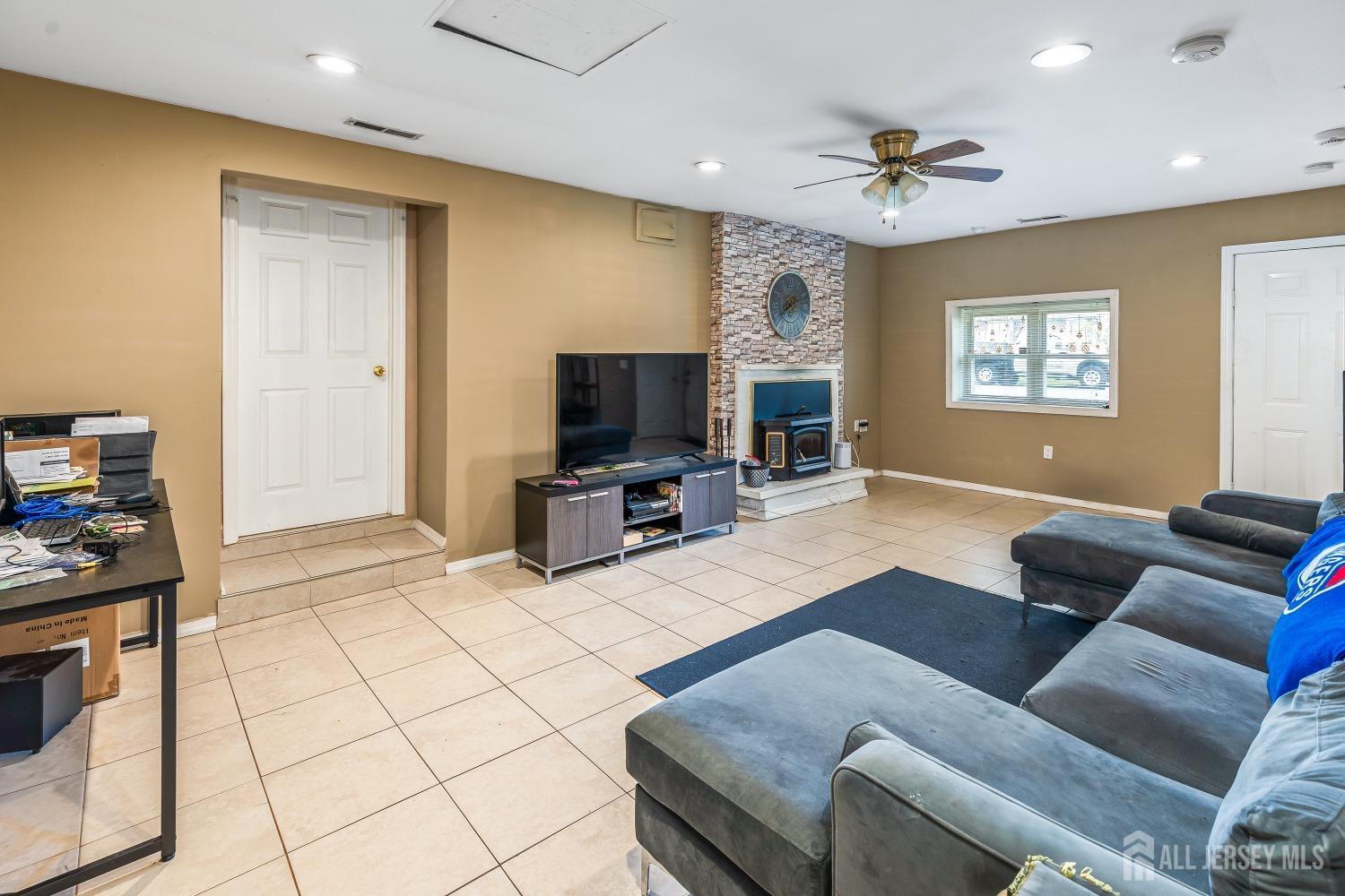 560 Lloyd Road Toms River, NJ 08753 - Photo 4 of 18 a living room with furniture and a flat screen tv