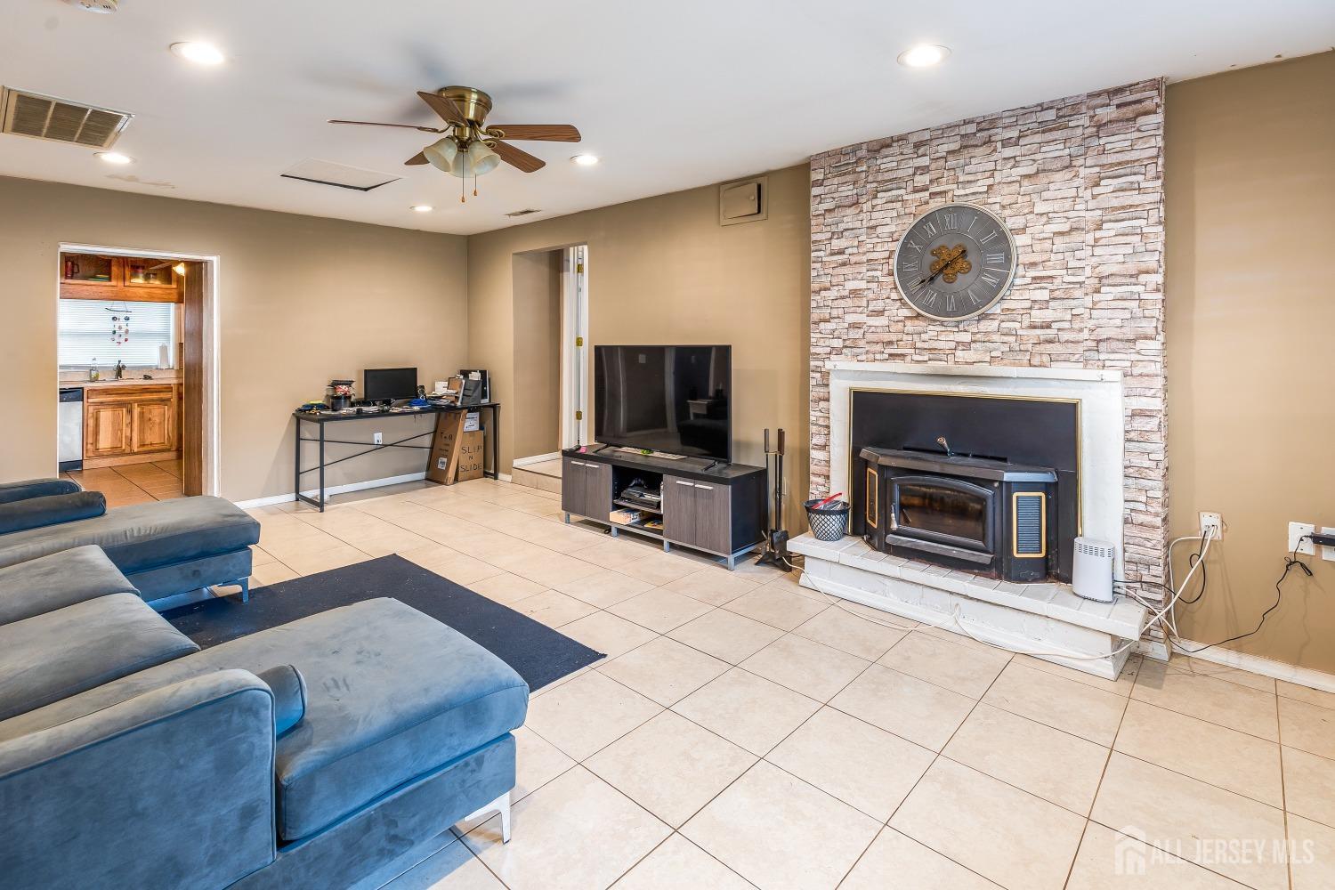 560 Lloyd Road Toms River, NJ 08753 - Photo 5 of 18 a living room with furniture and a fireplace