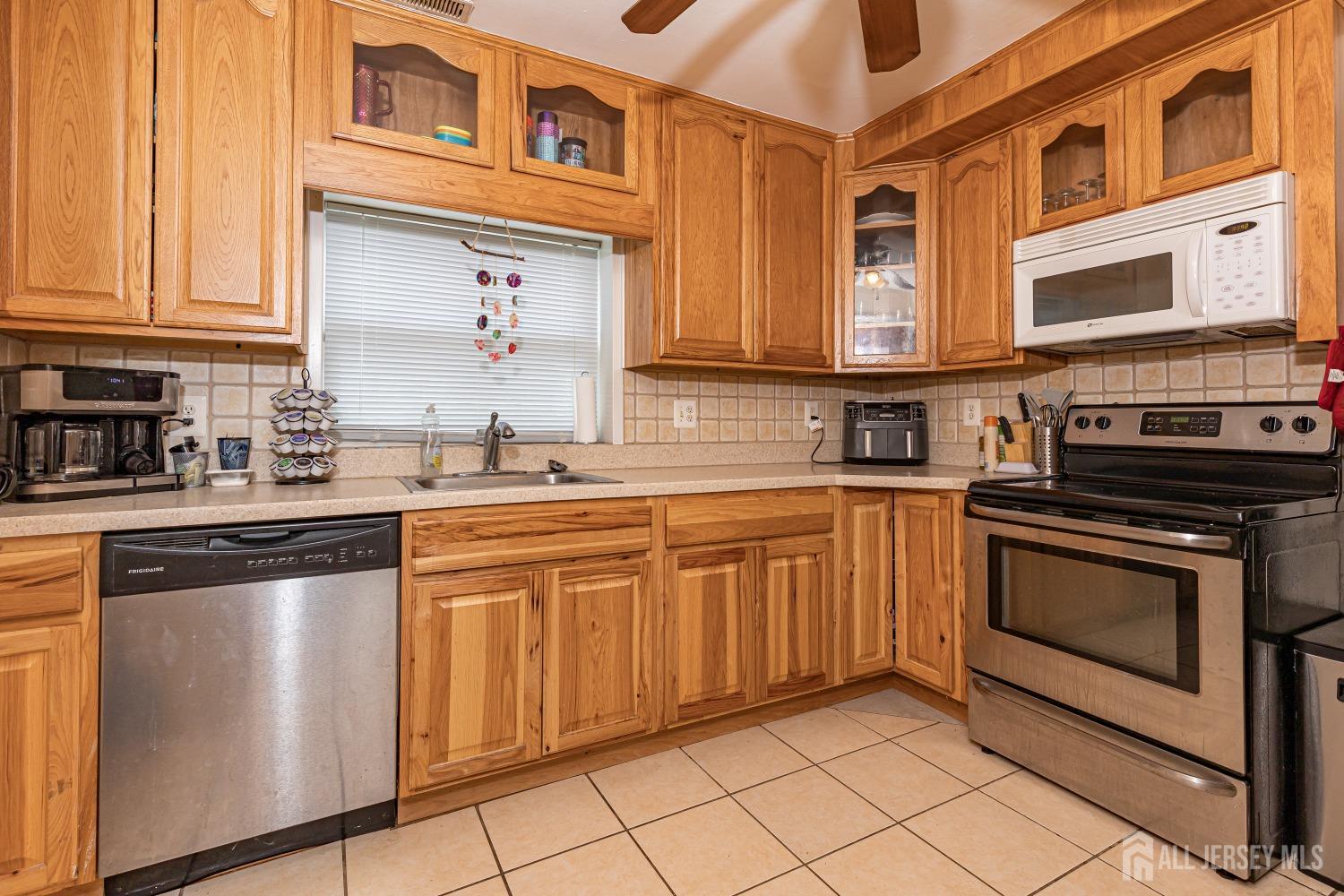 560 Lloyd Road Toms River, NJ 08753 - Photo 8 of 18 a kitchen with stainless steel appliances granite countertop a stove sink and cabinets