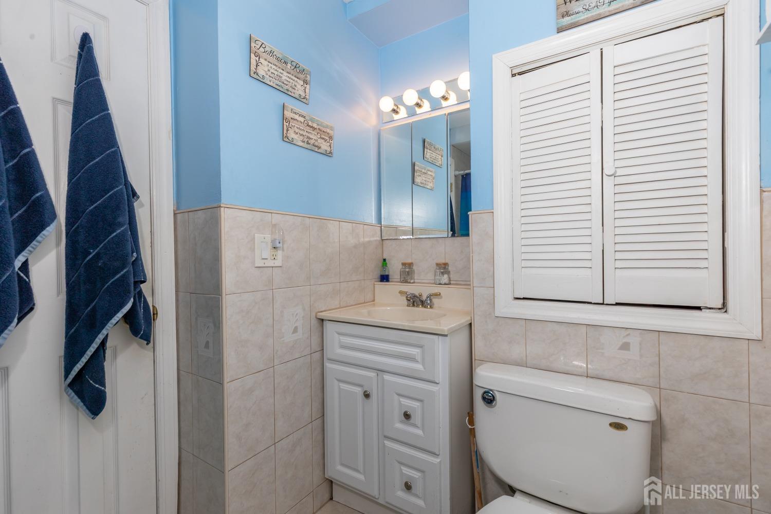 560 Lloyd Road Toms River, NJ 08753 - Photo 9 of 18 a bathroom with a sink a toilet and mirror