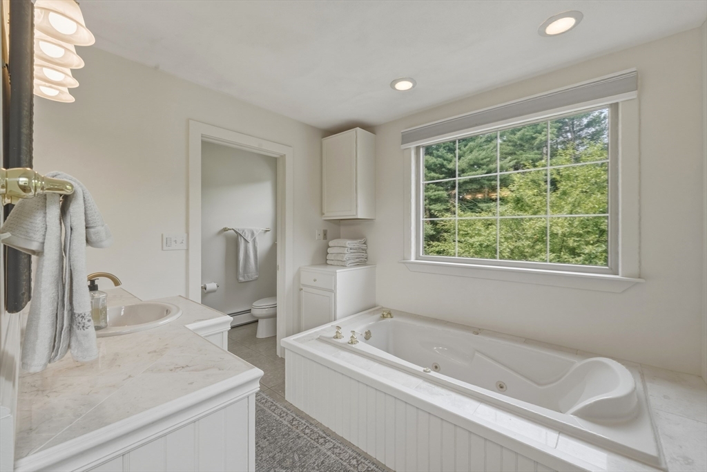 90 Rounsevell Road Tewksbury, MA 01876 - Photo 24 of 42 a bathroom with a granite countertop sink and a bathtub