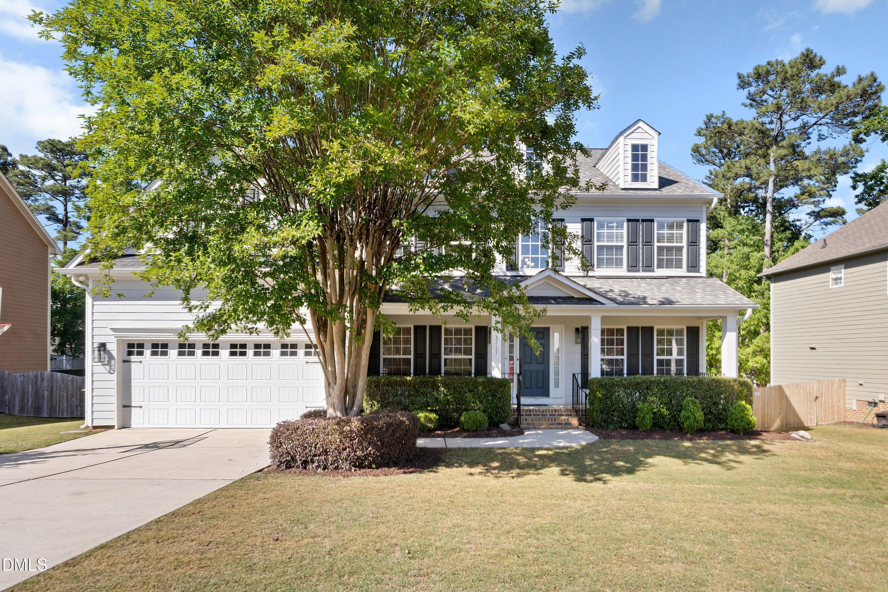 3717 Windmeade Road Wake Forest, NC 27587 - Photo 4 of 51 a front view of a house with a yard and potted plants