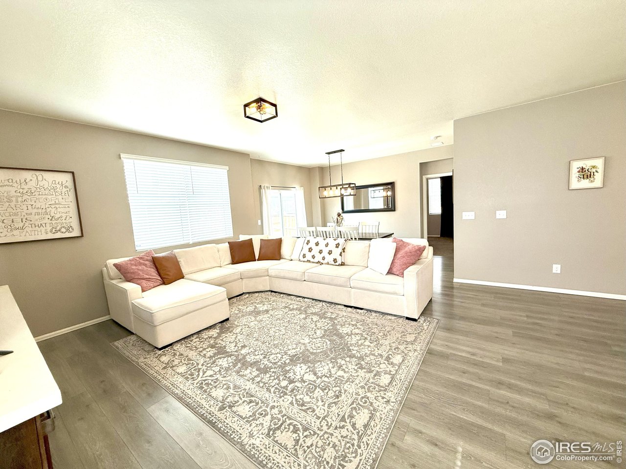 1780 Floret Drive Windsor, CO 80550 - Photo 11 of 36 a living room with furniture and a large window