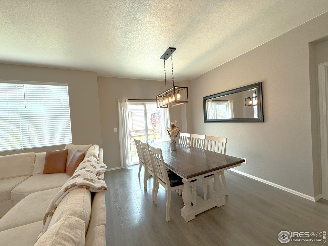 1780 Floret Drive Windsor, CO 80550 - Photo 12 of 36 a dining room with furniture and wooden floor