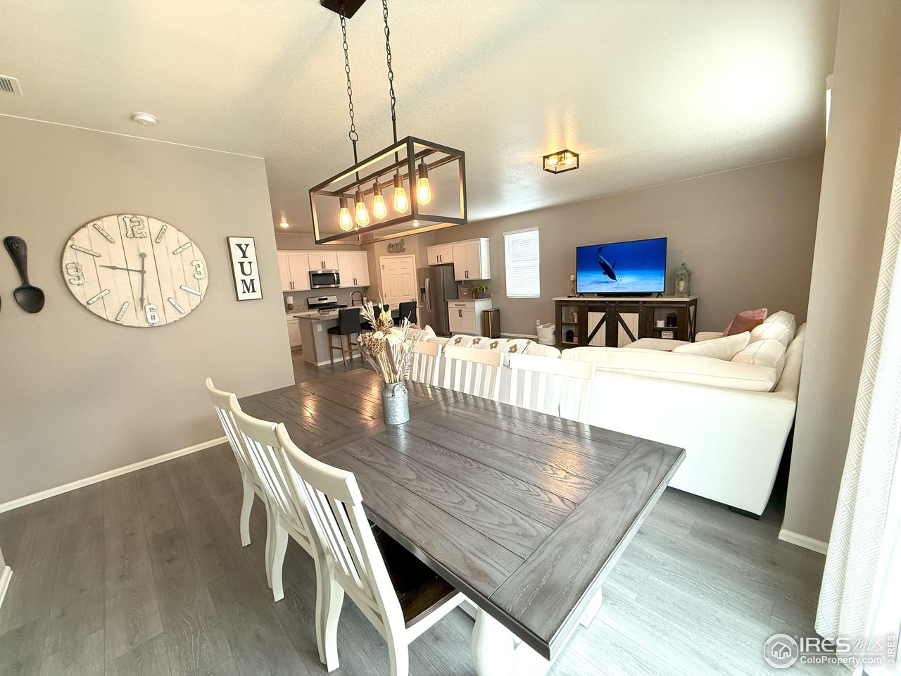 1780 Floret Drive Windsor, CO 80550 - Photo 13 of 36 a view of a dining room with furniture and a chandelier