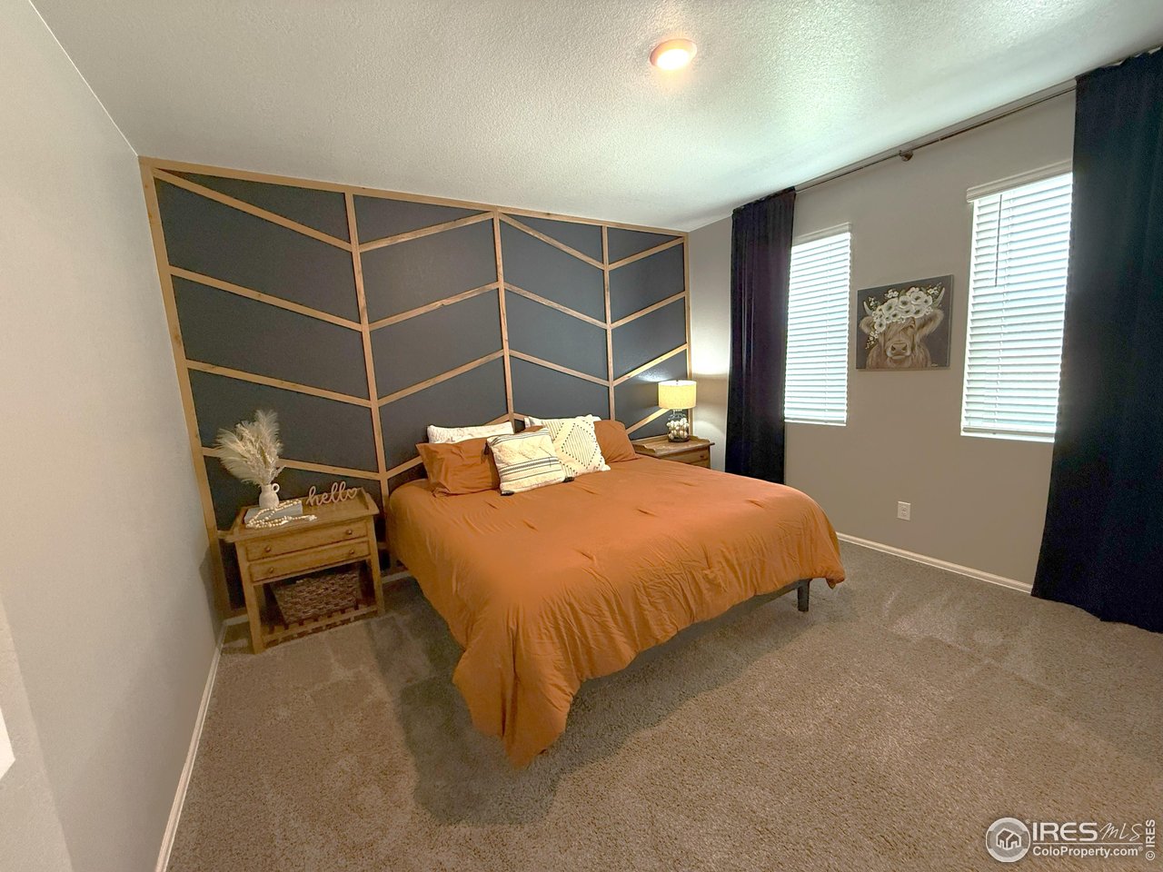 1780 Floret Drive Windsor, CO 80550 - Photo 14 of 36 a bedroom with a bed and wooden floor
