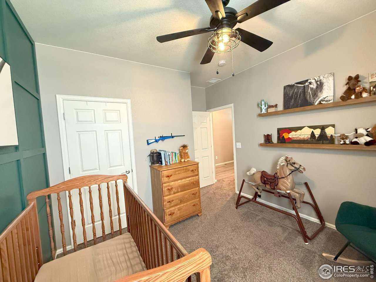 1780 Floret Drive Windsor, CO 80550 - Photo 21 of 36 a bedroom with furniture and a chair
