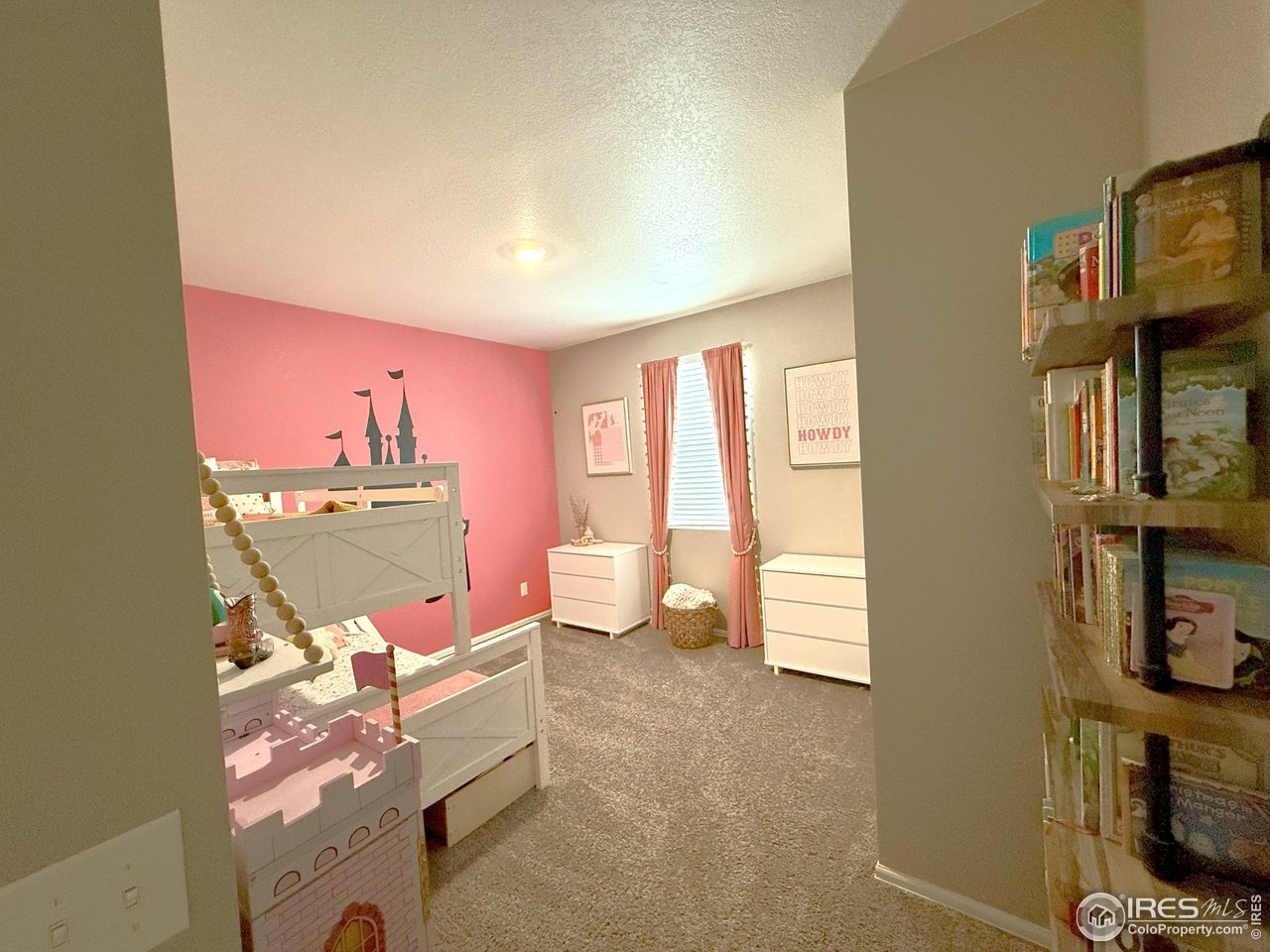 1780 Floret Drive Windsor, CO 80550 - Photo 24 of 36 a living room with furniture a rug and a wall painting