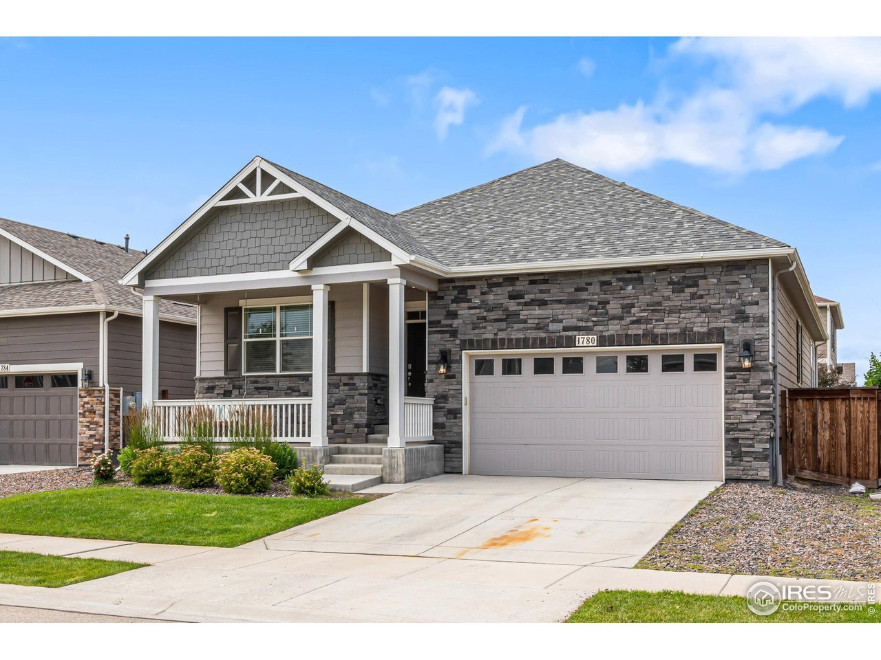 1780 Floret Drive Windsor, CO 80550 - Photo 3 of 36 a front view of a house with a garden