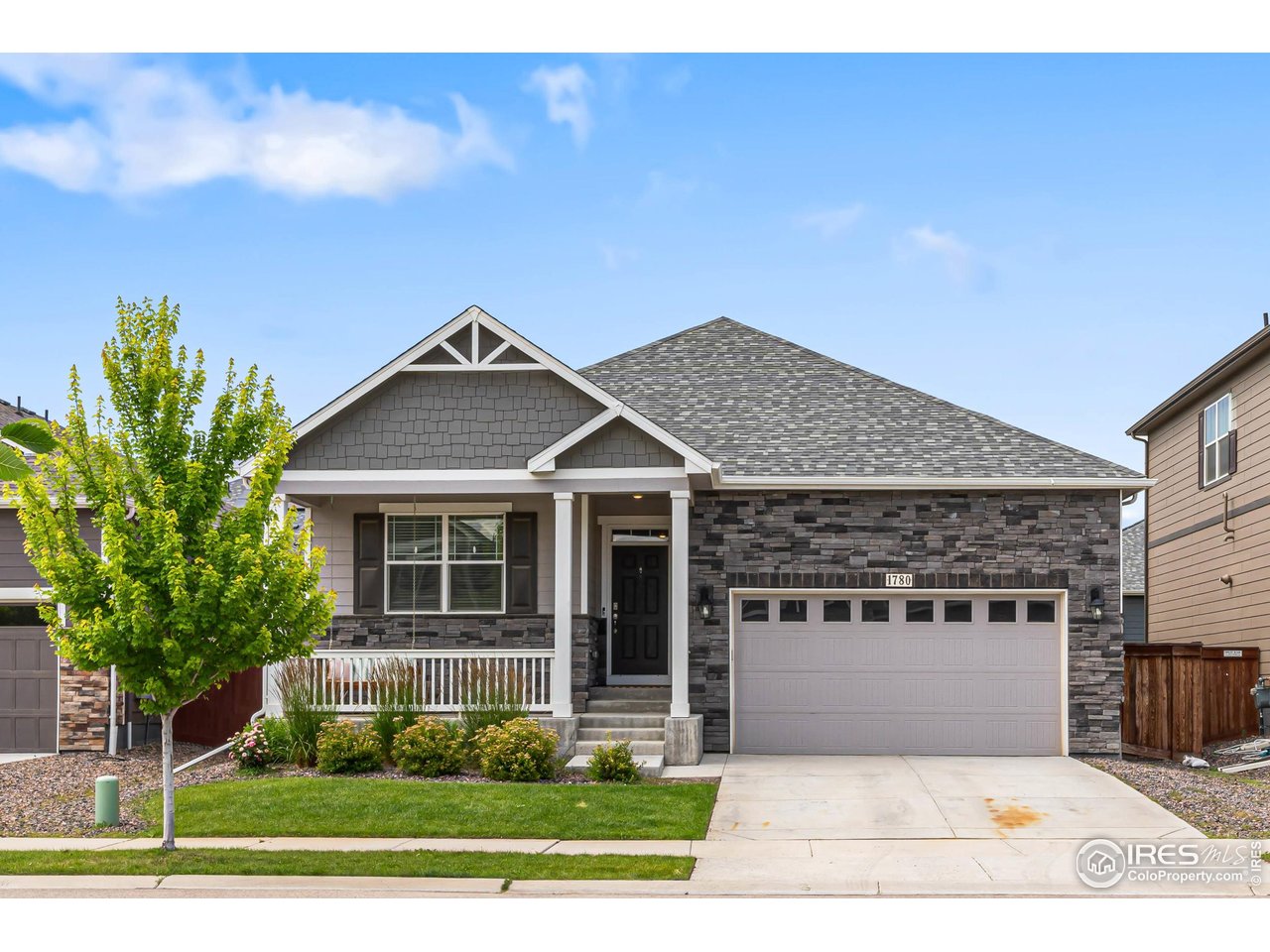 1780 Floret Drive Windsor, CO 80550 - Photo 35 of 36 a front view of a house with a yard