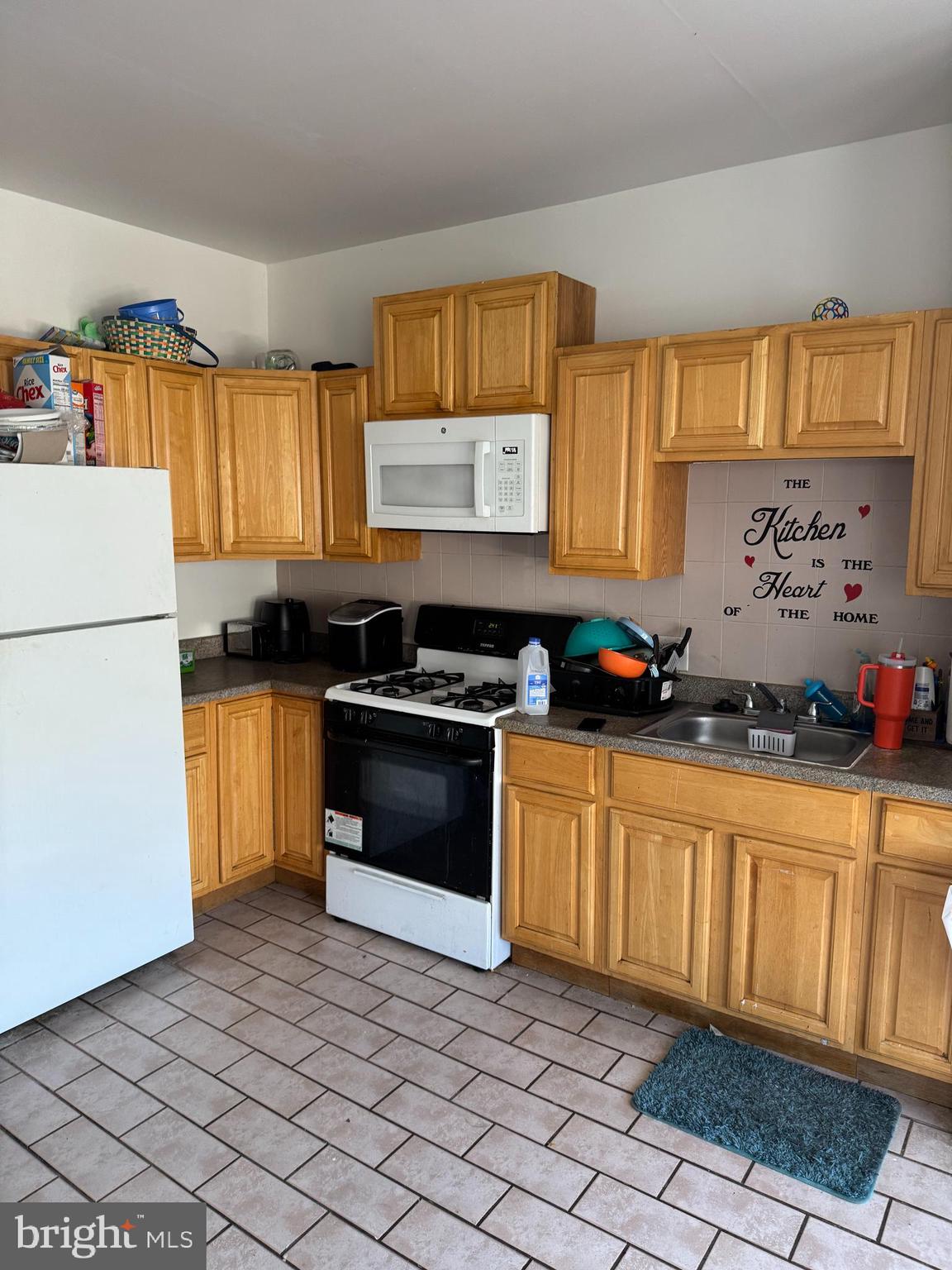 1736 McCulloh Street Baltimore, MD 21217 - Photo 3 of 14 a kitchen with granite countertop a stove a sink and a refrigerator