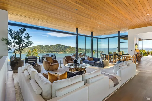 a living room with couch floor to ceiling window and a floor to ceiling window