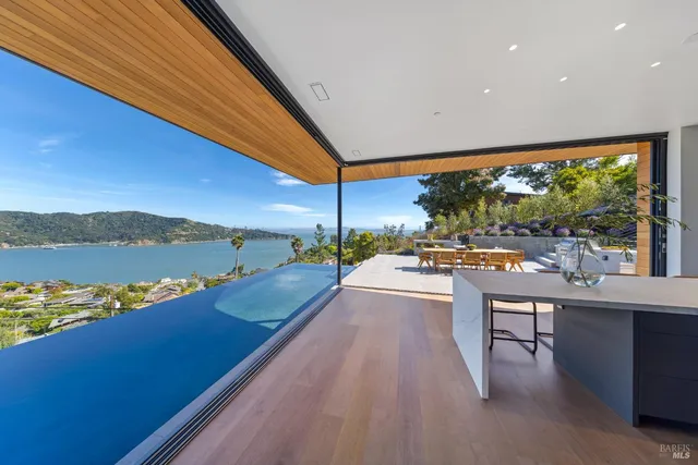 a view of a balcony with two chairs and a table