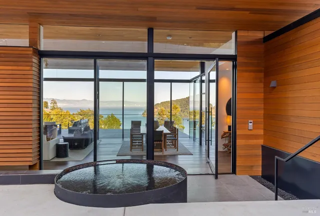 a view of a balcony with couch and chairs