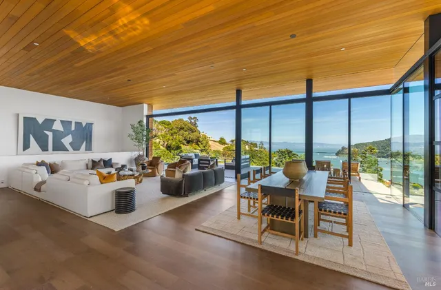 a roof deck with table and chairs a barbeque