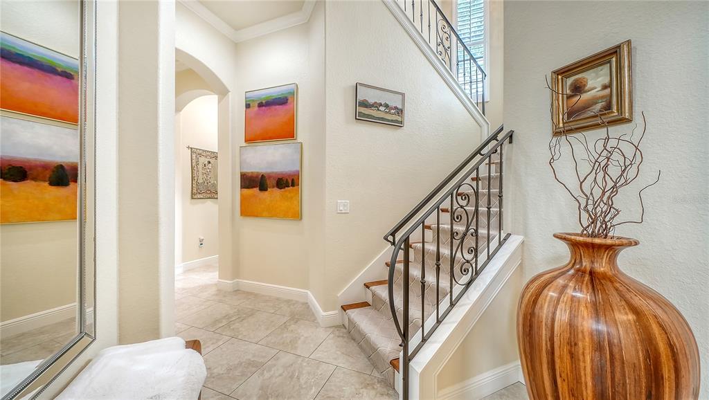 1630 Assisi Drive, Unit 18 Sarasota, FL 34231 - Photo 20 of 42 a view of staircase with lots of frames on wall and a large window