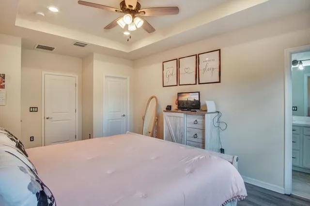 a bedroom with a bed and a chandelier