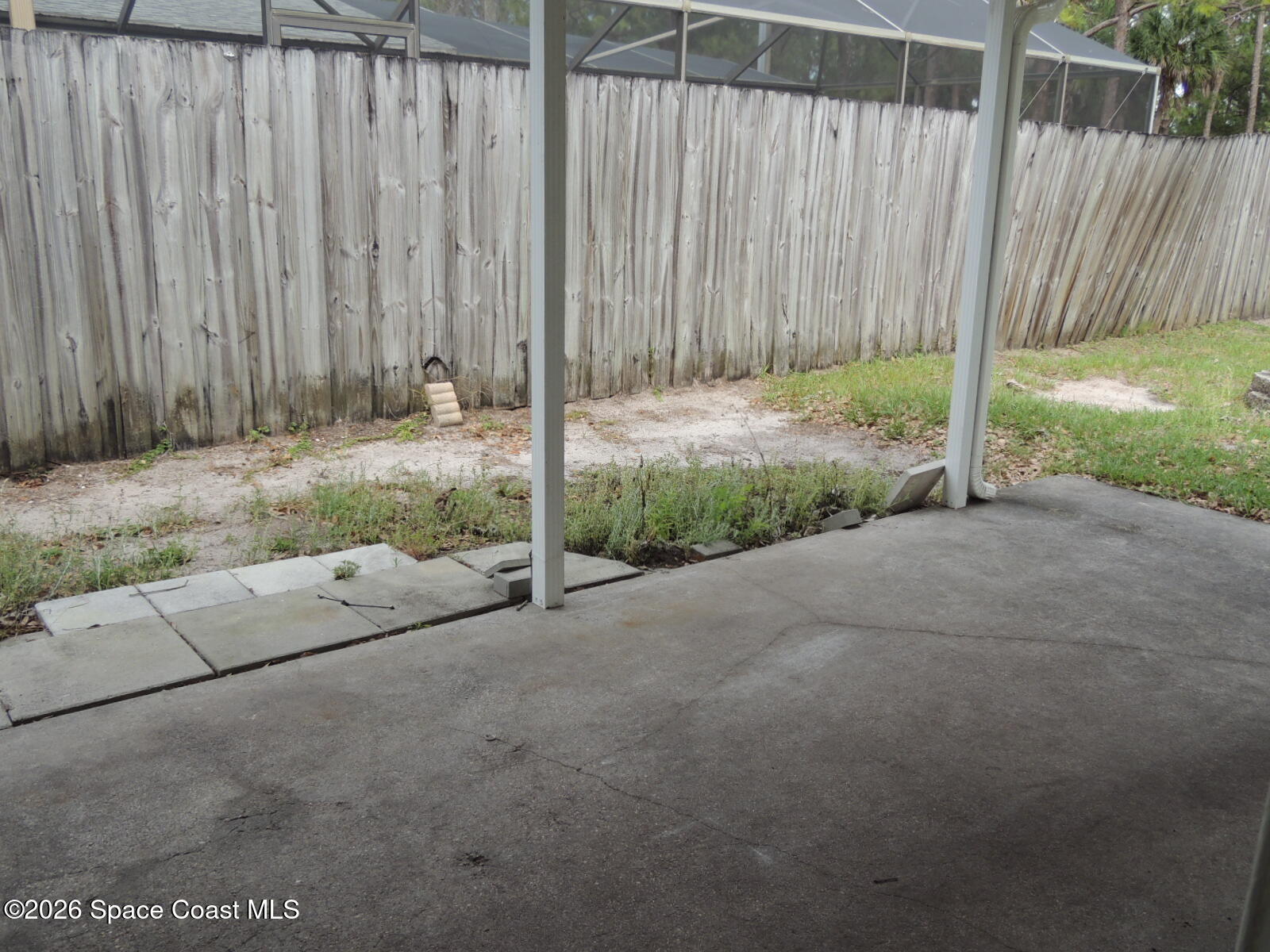 1312 Huntington Lane Rockledge, FL 32955 - Photo 9 of 21 a view of a backyard with wooden fence