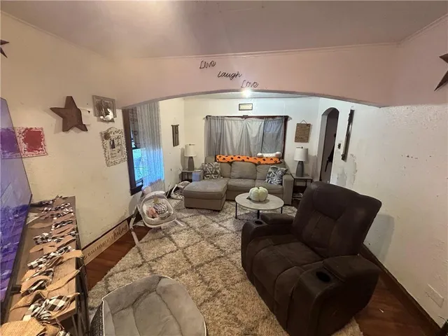 a living room with furniture and a chandelier