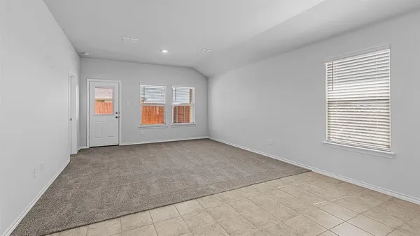 a kitchen with stainless steel appliances granite countertop a refrigerator oven a sink and white cabinets