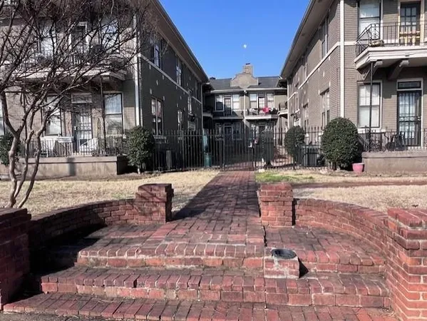 a view of a building with a yard