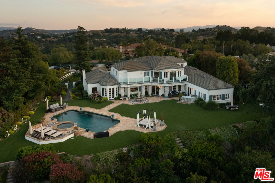 5933 Annie Oakley Road Hidden Hills, CA 91302 - Photo 1 of 22 a view of a house with swimming pool and a yard