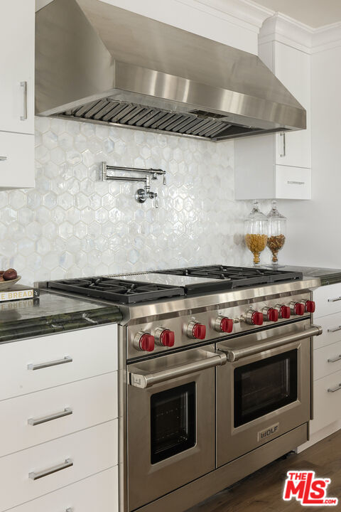 5933 Annie Oakley Road Hidden Hills, CA 91302 - Photo 11 of 22 a stove top oven sitting inside of a kitchen