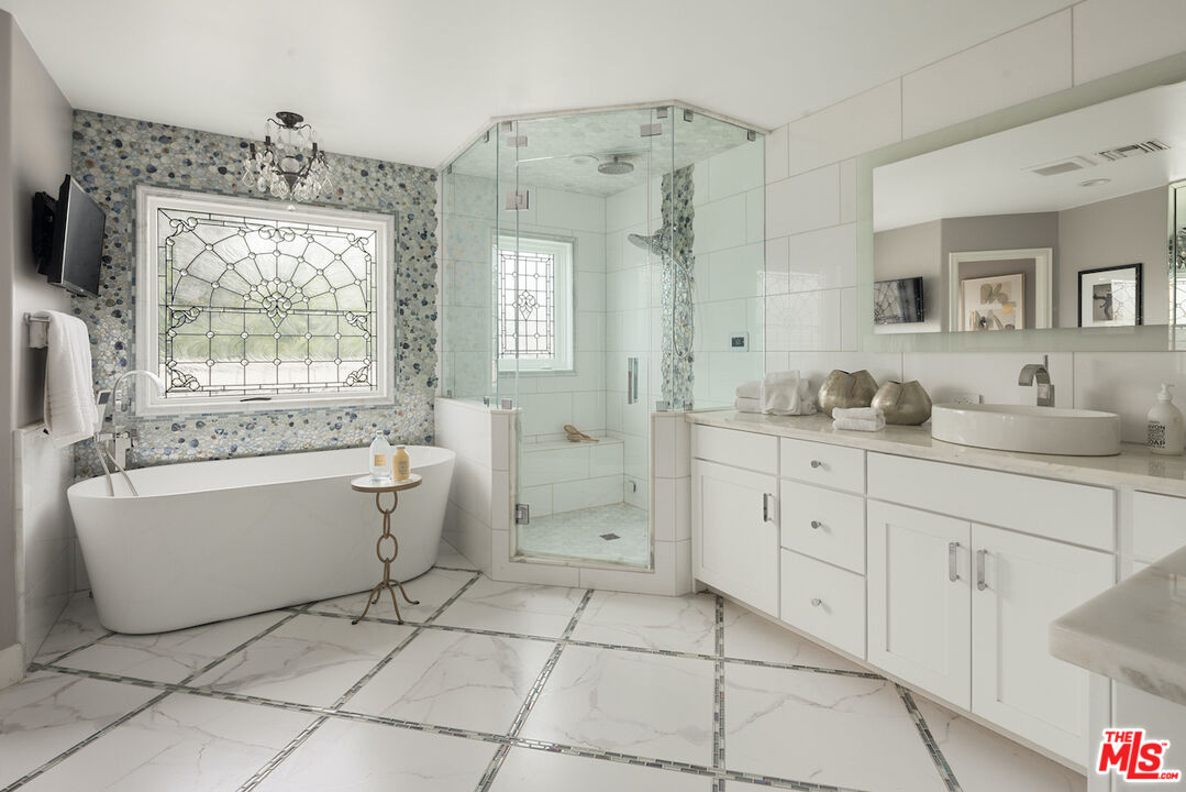 5933 Annie Oakley Road Hidden Hills, CA 91302 - Photo 19 of 22 a bathroom with a granite countertop sink mirror and bathtub