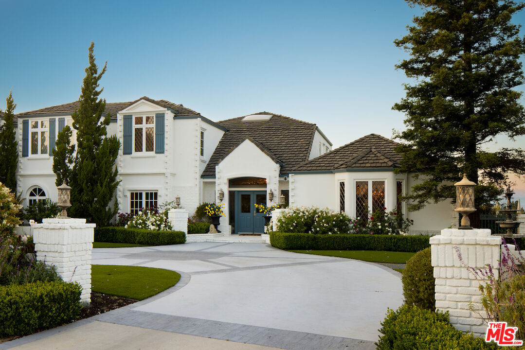 5933 Annie Oakley Road Hidden Hills, CA 91302 - Photo 3 of 22 a front view of a house with a garden