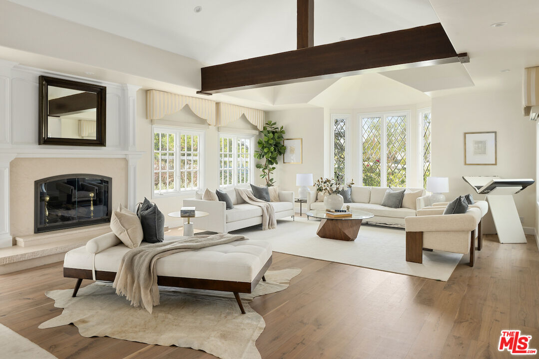 5933 Annie Oakley Road Hidden Hills, CA 91302 - Photo 5 of 22 a living room with furniture fireplace and a large window