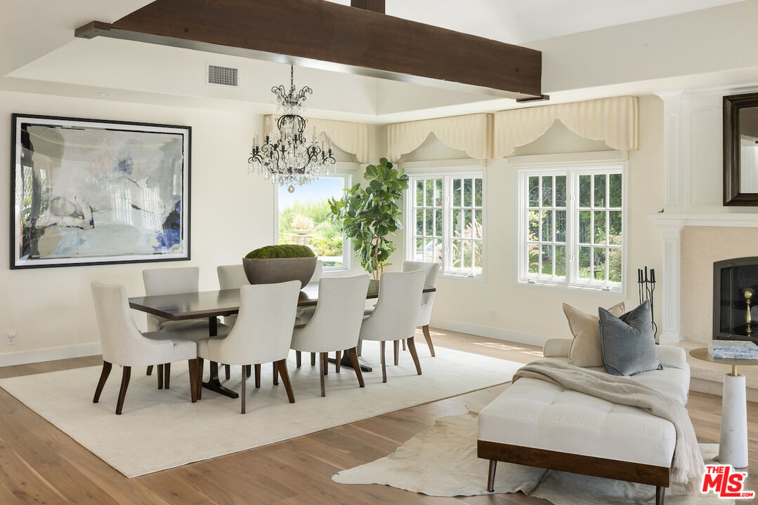 5933 Annie Oakley Road Hidden Hills, CA 91302 - Photo 8 of 22 a dining room with furniture a chandelier and wooden floor