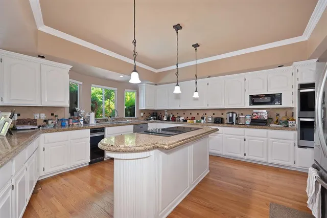 a bedroom with a bed and a flat tv screen on the dresser