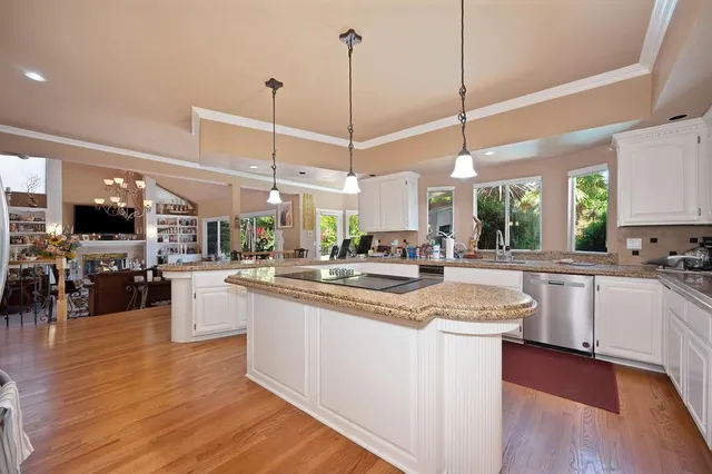 a living room with furniture and a view of kitchen