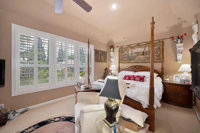 a view of a house with fountain and a garden