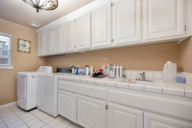 a view of a house with swimming pool and sitting area