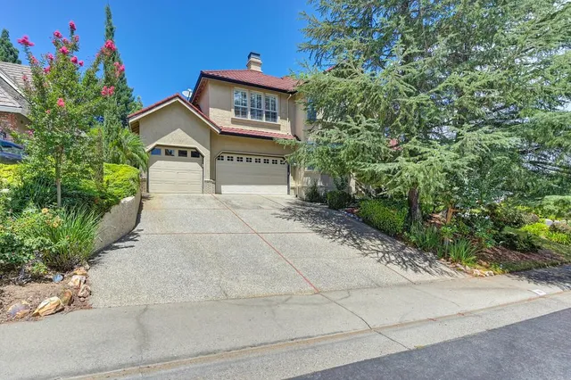 a living room with furniture fireplace and a large window