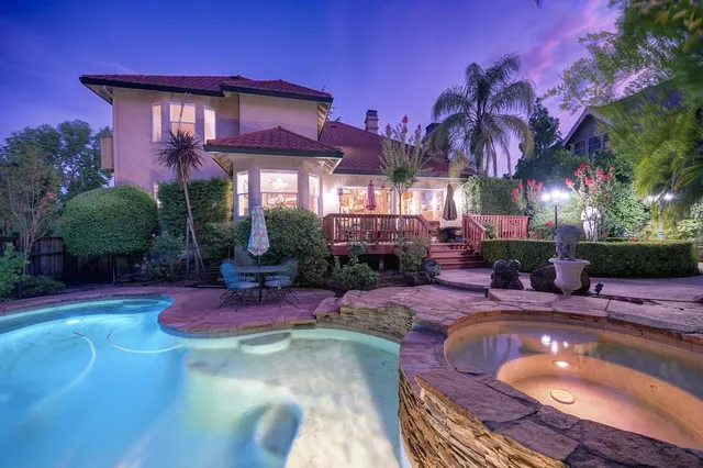 a view of a house with a garden and pathway