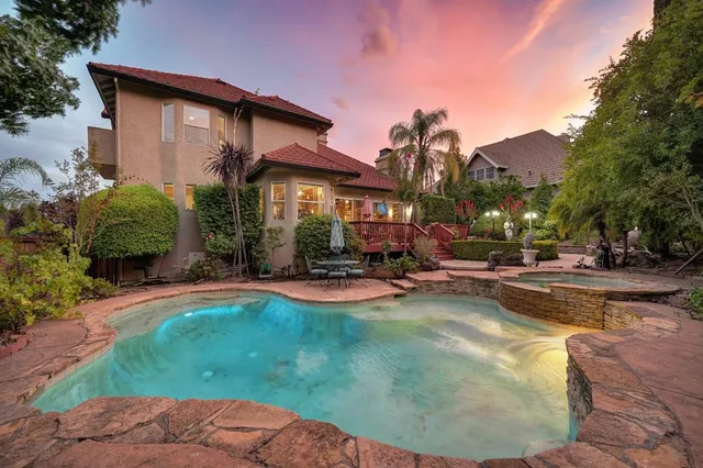a view of a house with backyard porch and sitting area