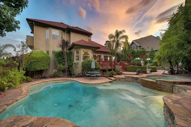 a view of a house with swimming pool yard and a patio